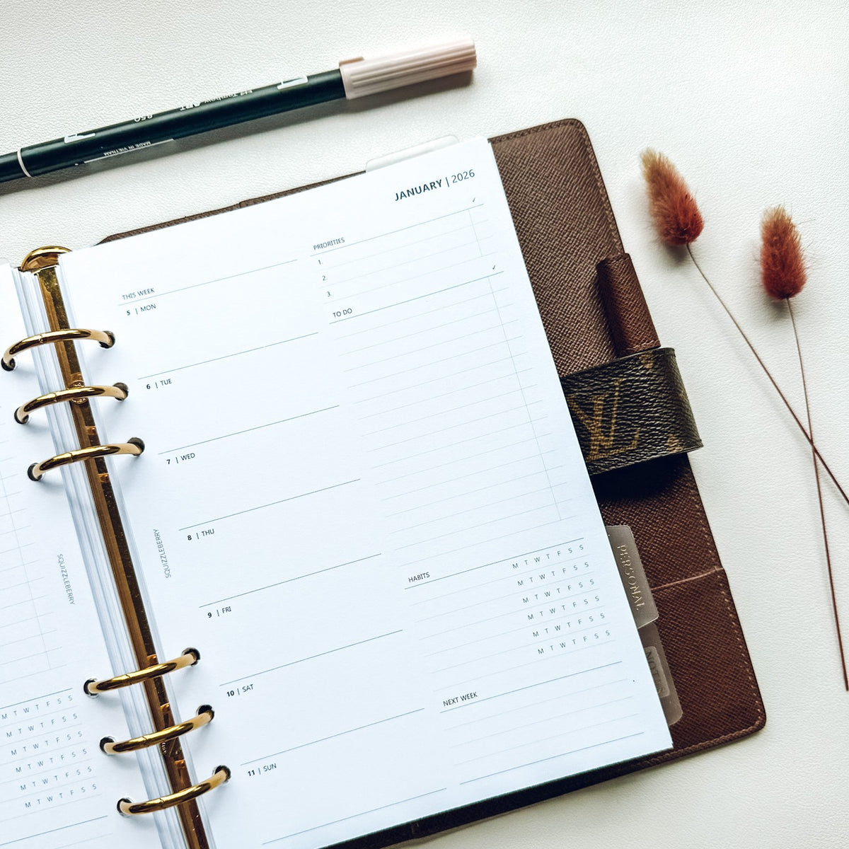 Minimalist 2026 Wo1P weekly planner insert open in Louis Vuitton Agenda GM size